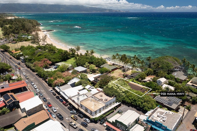 drone / aerial view featuring a water view and a beach view