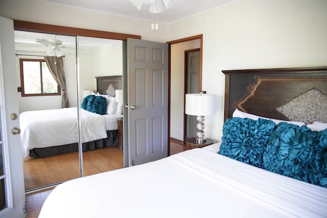 bedroom with ceiling fan, hardwood / wood-style flooring, and a closet