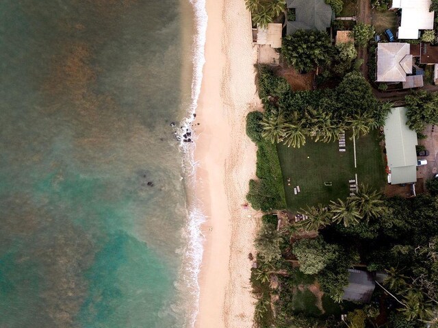 birds eye view of property with a water view and a view of the beach