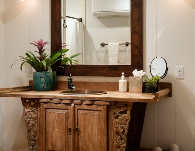 bathroom featuring vanity and an AC wall unit