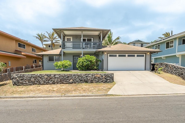 1395 Hiahia St, Wailuku, HI 96793 - view of front of property featuring stucco siding, an attached garage, a balcony, and driveway