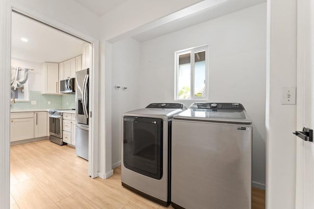 1395 Hiahia St, Wailuku, HI 96793 - laundry room with independent washer and dryer and light wood-style flooring