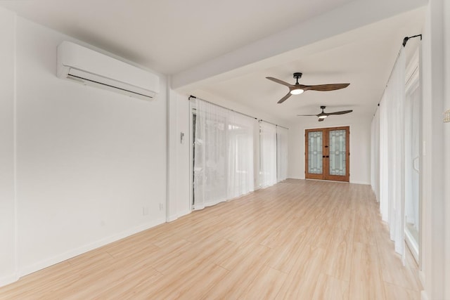 1395 Hiahia St, Wailuku, HI 96793 - spare room with a wall unit AC, french doors, light wood-type flooring, ceiling fan, and baseboards