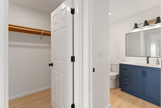 1395 Hiahia St, Wailuku, HI 96793 - bathroom with wood finished floors, vanity, toilet, and baseboards