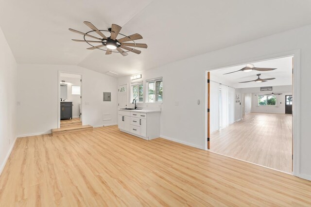 1395 Hiahia St, Wailuku, HI 96793 - unfurnished living room featuring a ceiling fan, a sink, light wood finished floors, vaulted ceiling, and baseboards