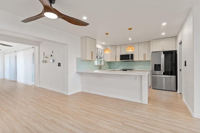1395 Hiahia St, Wailuku, HI 96793 - kitchen with stainless steel appliances, ceiling fan, a sink, light countertops, and decorative backsplash