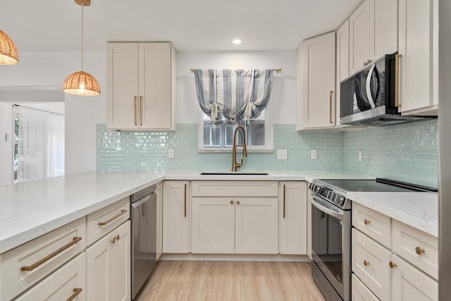 1395 Hiahia St, Wailuku, HI 96793 - kitchen featuring appliances with stainless steel finishes, a sink, hanging light fixtures, tasteful backsplash, and light stone countertops