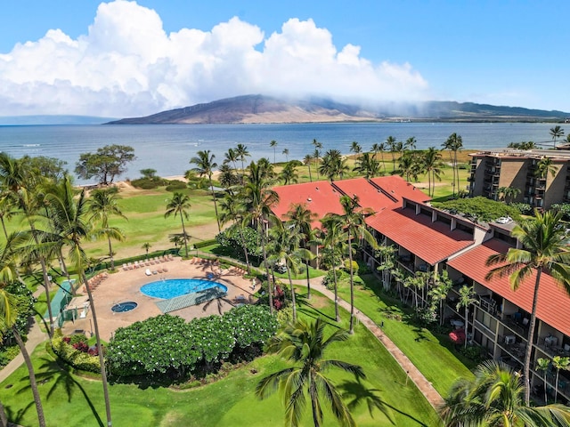 birds eye view of property with a water and mountain view