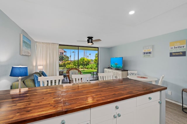 kitchen featuring butcher block countertops, hardwood / wood-style floors, and ceiling fan