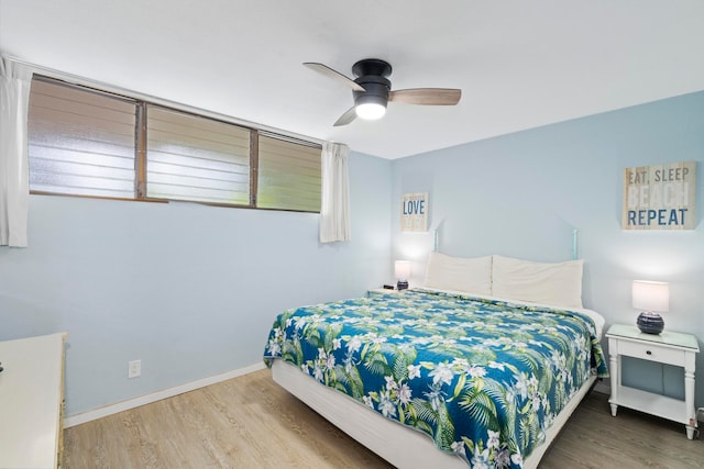 bedroom with ceiling fan and wood-type flooring