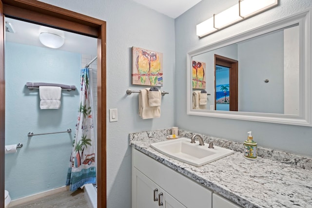 bathroom featuring hardwood / wood-style flooring, vanity, and a shower with shower curtain