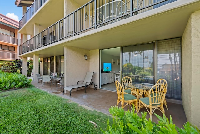 view of patio featuring a balcony