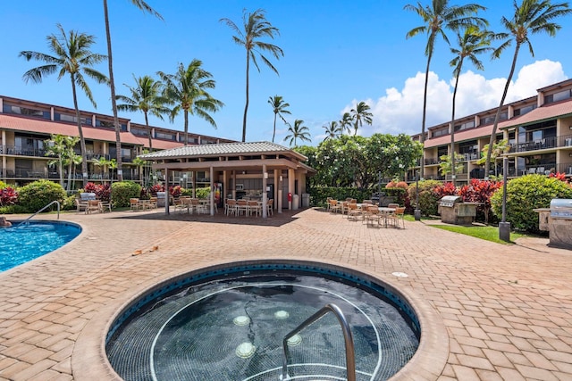 view of pool with a community hot tub and a patio