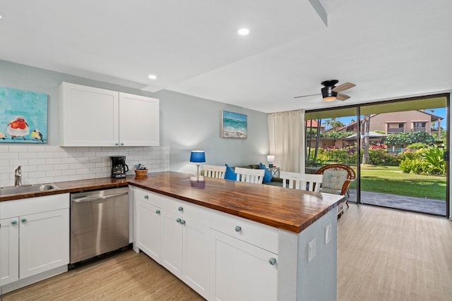 kitchen featuring backsplash, white cabinetry, light hardwood / wood-style floors, dishwasher, and sink