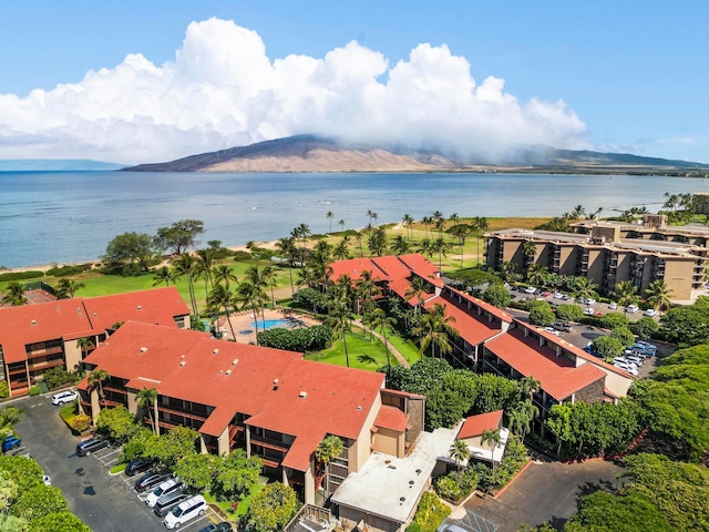 birds eye view of property with a water and mountain view