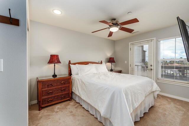 bedroom with light carpet, ceiling fan, and a closet