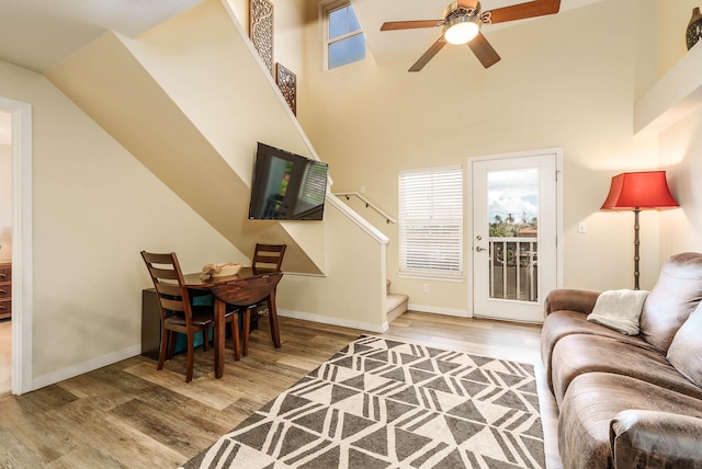 living room with hardwood / wood-style floors and ceiling fan