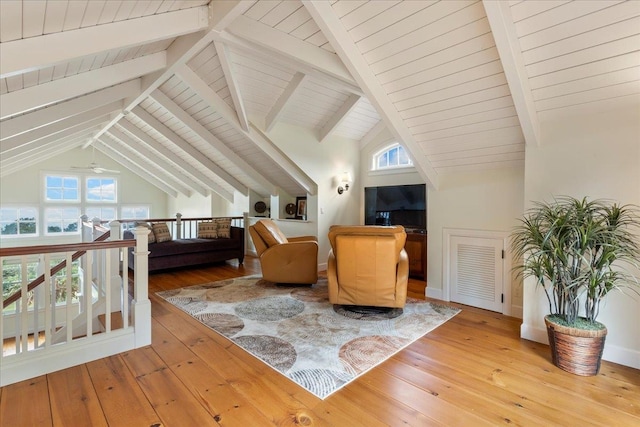 sitting room featuring high vaulted ceiling, beamed ceiling, wood-type flooring, and ceiling fan