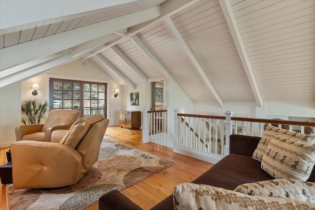sitting room with wood-type flooring and lofted ceiling with beams