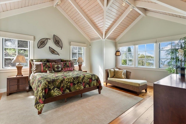 bedroom featuring high vaulted ceiling, light wood-type flooring, multiple windows, and beamed ceiling