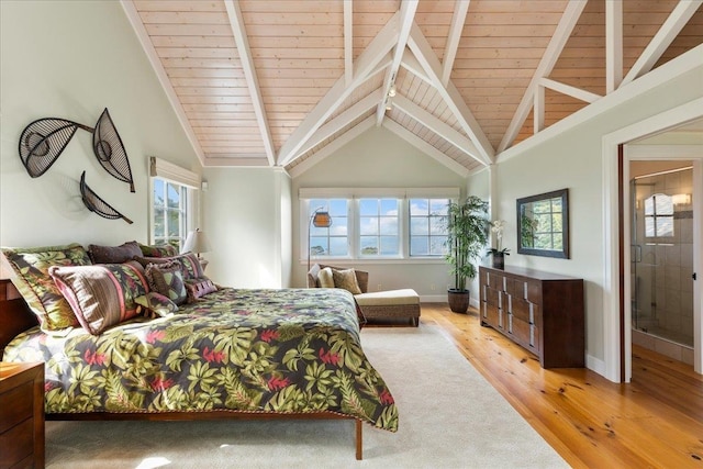 bedroom featuring multiple windows, light hardwood / wood-style flooring, connected bathroom, and wood ceiling