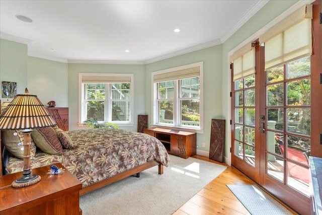 bedroom with ornamental molding, access to outside, french doors, and light hardwood / wood-style floors