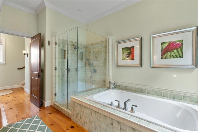 bathroom with plus walk in shower, hardwood / wood-style flooring, and ornamental molding