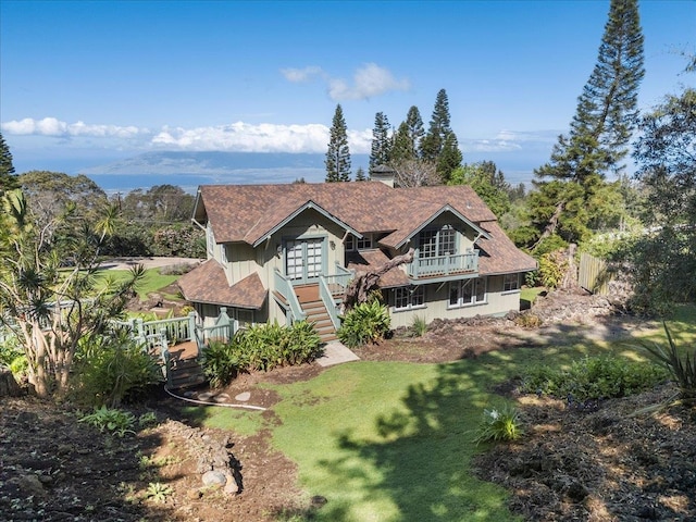 view of front of house featuring a front lawn and a wooden deck