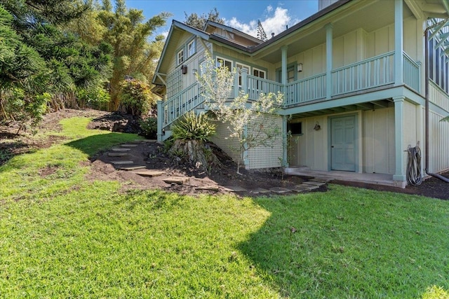 view of home's exterior featuring a yard and a balcony