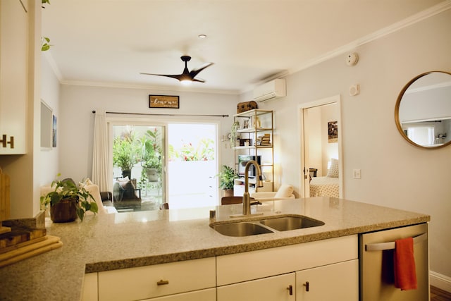 kitchen featuring light stone counters, a wall unit AC, a sink, and stainless steel dishwasher