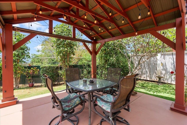 view of patio / terrace with a fenced backyard, outdoor dining space, and a gazebo