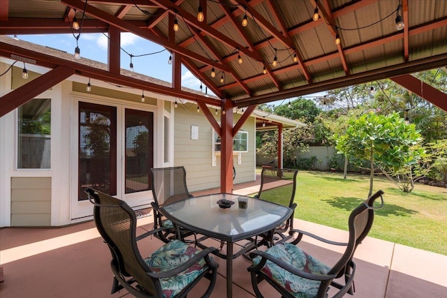 view of patio / terrace featuring outdoor dining area, fence, and a gazebo