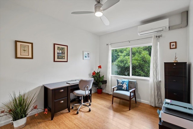 home office with an AC wall unit, a ceiling fan, light wood-style flooring, and baseboards