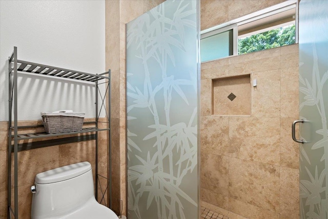 bathroom featuring toilet and a shower stall