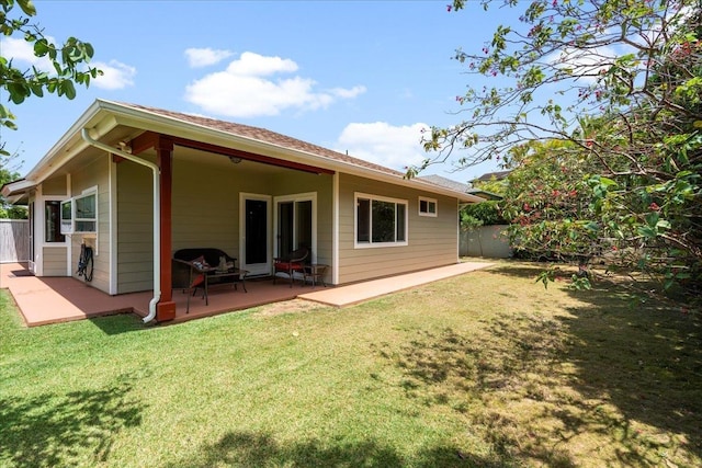 back of house featuring a yard, fence, and a patio area