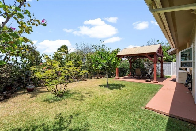 view of yard featuring fence, a patio, and a gazebo