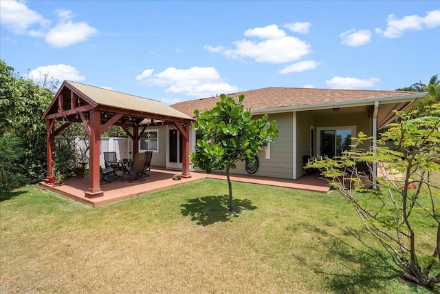 back of property with a gazebo, a yard, and a deck