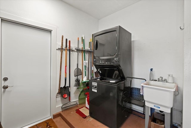 washroom with laundry area and stacked washer / drying machine