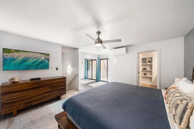 bedroom with ceiling fan and a wall mounted air conditioner