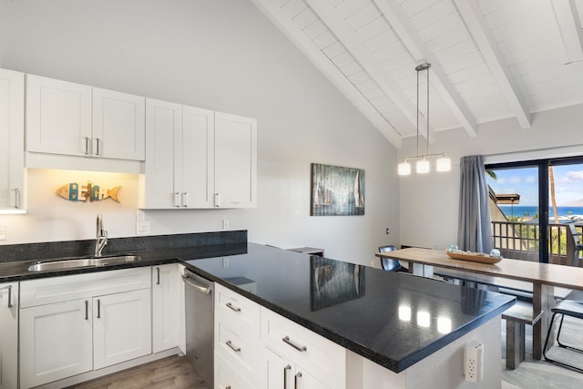 kitchen with decorative light fixtures, hardwood / wood-style floors, beam ceiling, white cabinets, and sink