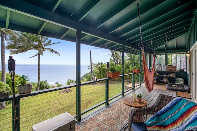 sunroom featuring a water view and lofted ceiling