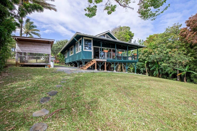 rear view of house with a lawn