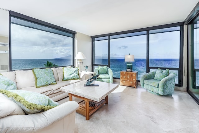 living room with floor to ceiling windows and a water view