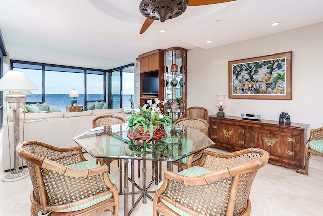 dining room with floor to ceiling windows and ceiling fan