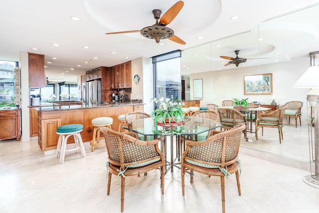 dining room with ceiling fan and expansive windows