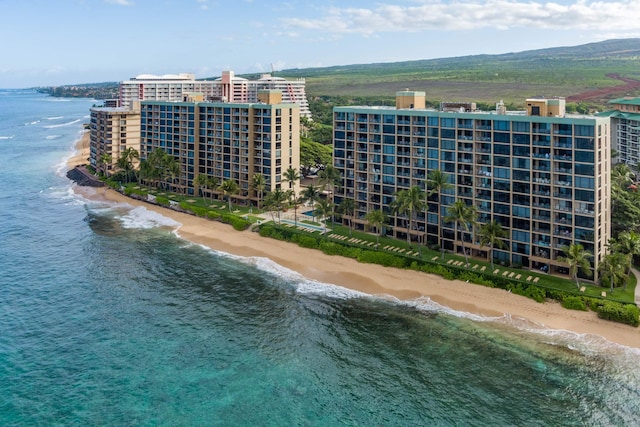 birds eye view of property featuring a water view and a beach view