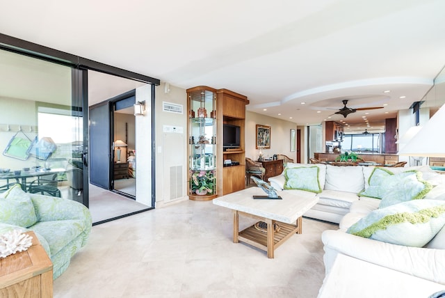 living room with floor to ceiling windows and ceiling fan