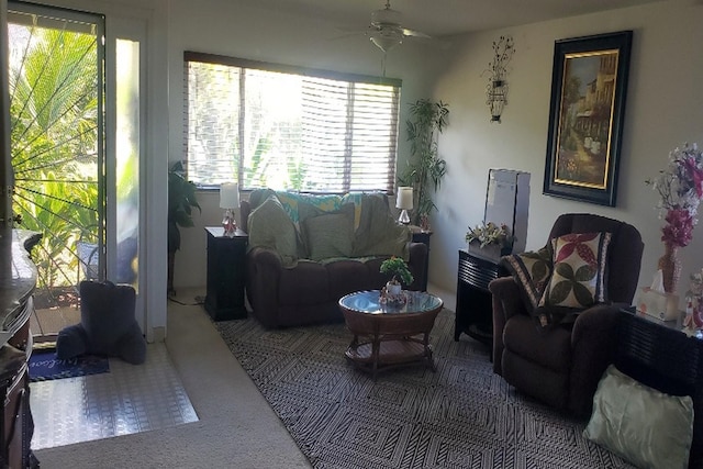 living room with ceiling fan, plenty of natural light, and carpet floors