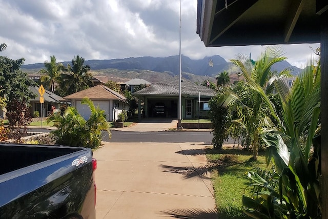 view of front facade featuring a mountain view and a garage