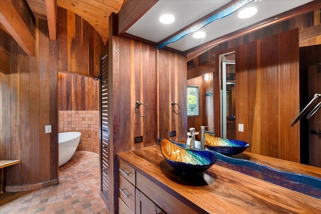 2450 Piiholo Rd, Makawao, HI 96768 - bathroom with wood walls, a freestanding bath, vanity, and brick patterned floors